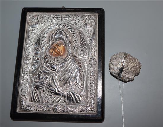 A silver icon and stone nut shaped box